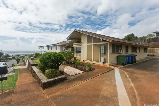a view of a house with backyard and sitting area