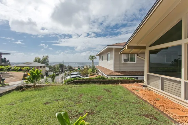 a view of a house with backyard and sitting area