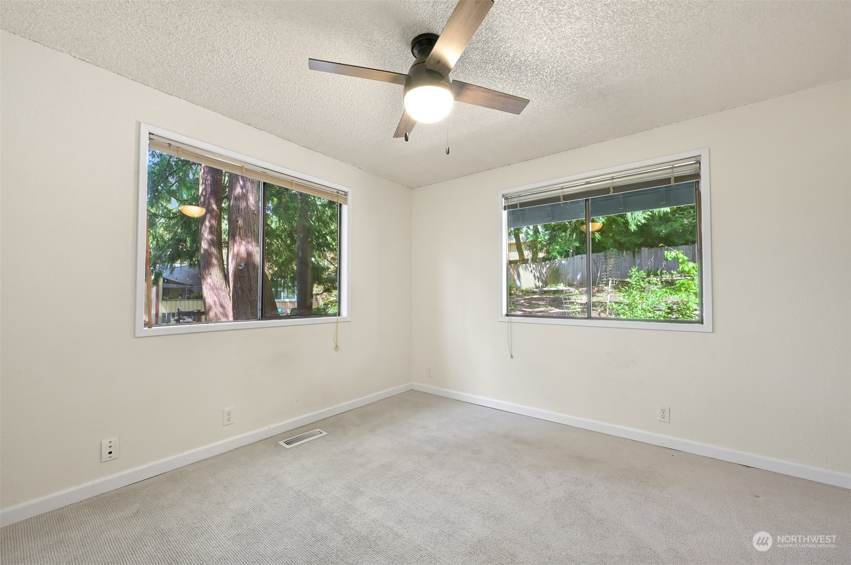 1506 Willowbrook Place Bellingham, WA 98229 - Photo 13 of 37 an empty room with windows and chandelier fan