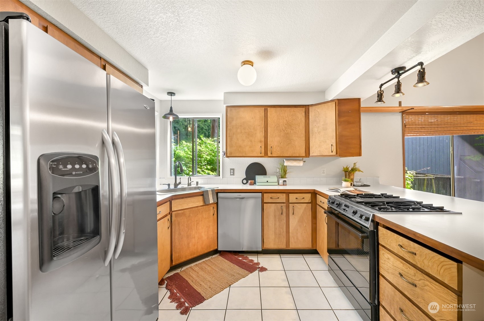 1506 Willowbrook Place Bellingham, WA 98229 - Photo 16 of 37 a kitchen with stainless steel appliances granite countertop a stove a sink and a refrigerator