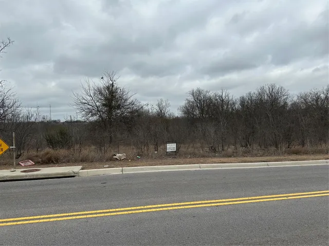 a view of a house with a snow on the road