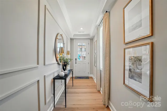 a view of a hallway with wooden floor and windows