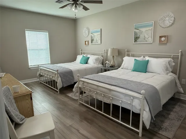 a bedroom with two beds and a chandelier