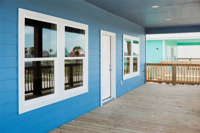 a view of a porch with wooden floor and a window