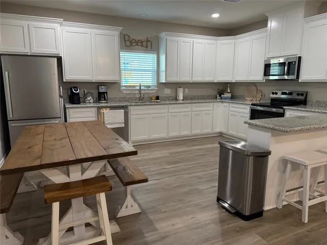 a kitchen with a stove a sink and a refrigerator