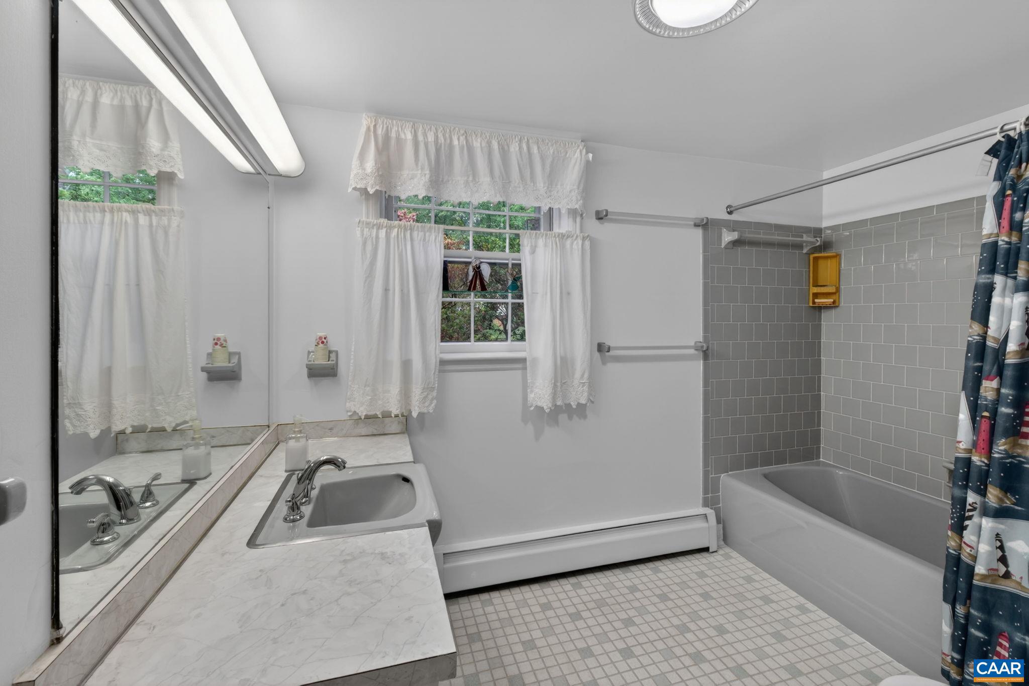 2409 Kerry Lane Charlottesville, VA 22901 - Photo 46 of 54 a bathroom with a tub a sink a window and a shower