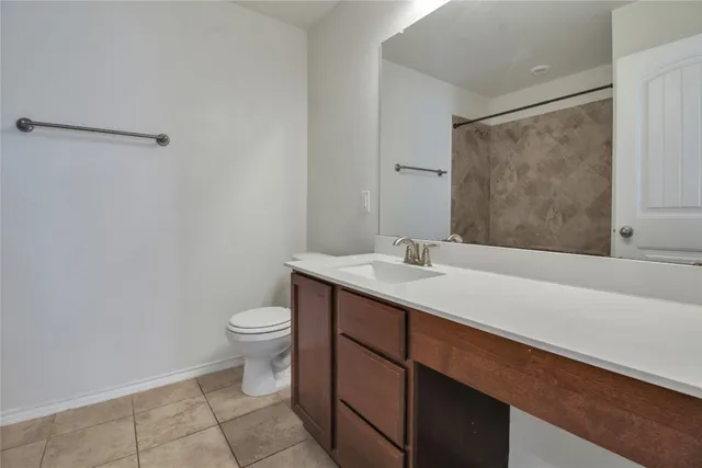an empty room with ceiling fan and window