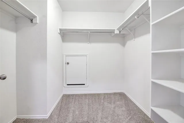 a view of a room with ceiling fan and window