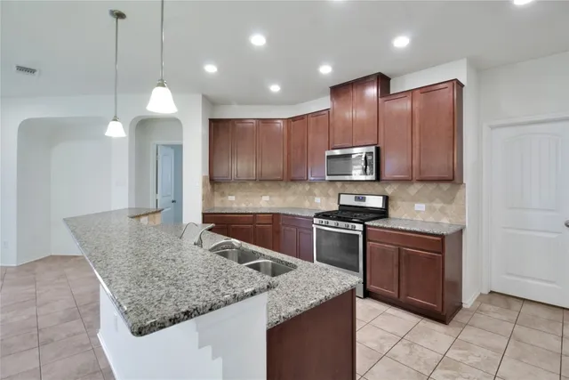 a kitchen with stainless steel appliances granite countertop granite counter tops and a stove