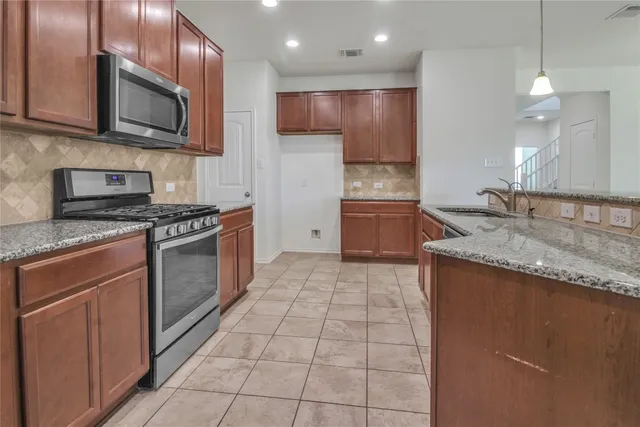 a view of a kitchen with a sink and a refrigerator