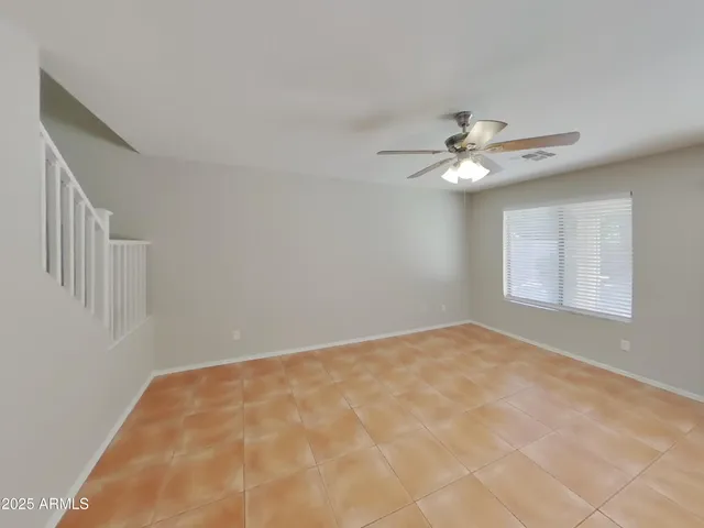 a picture of a room with a white wall and white refrigerator