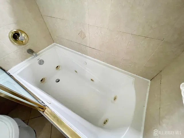 a bathroom with a tub and shower