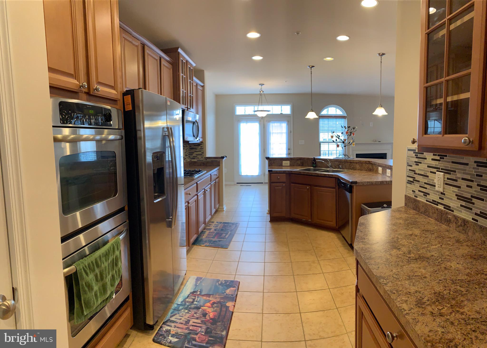 2816 Admiral Ridge Road Accokeek, MD 20607 - Photo 13 of 38 a large kitchen with stainless steel appliances granite countertop a refrigerator a oven and a sink with granite countertops