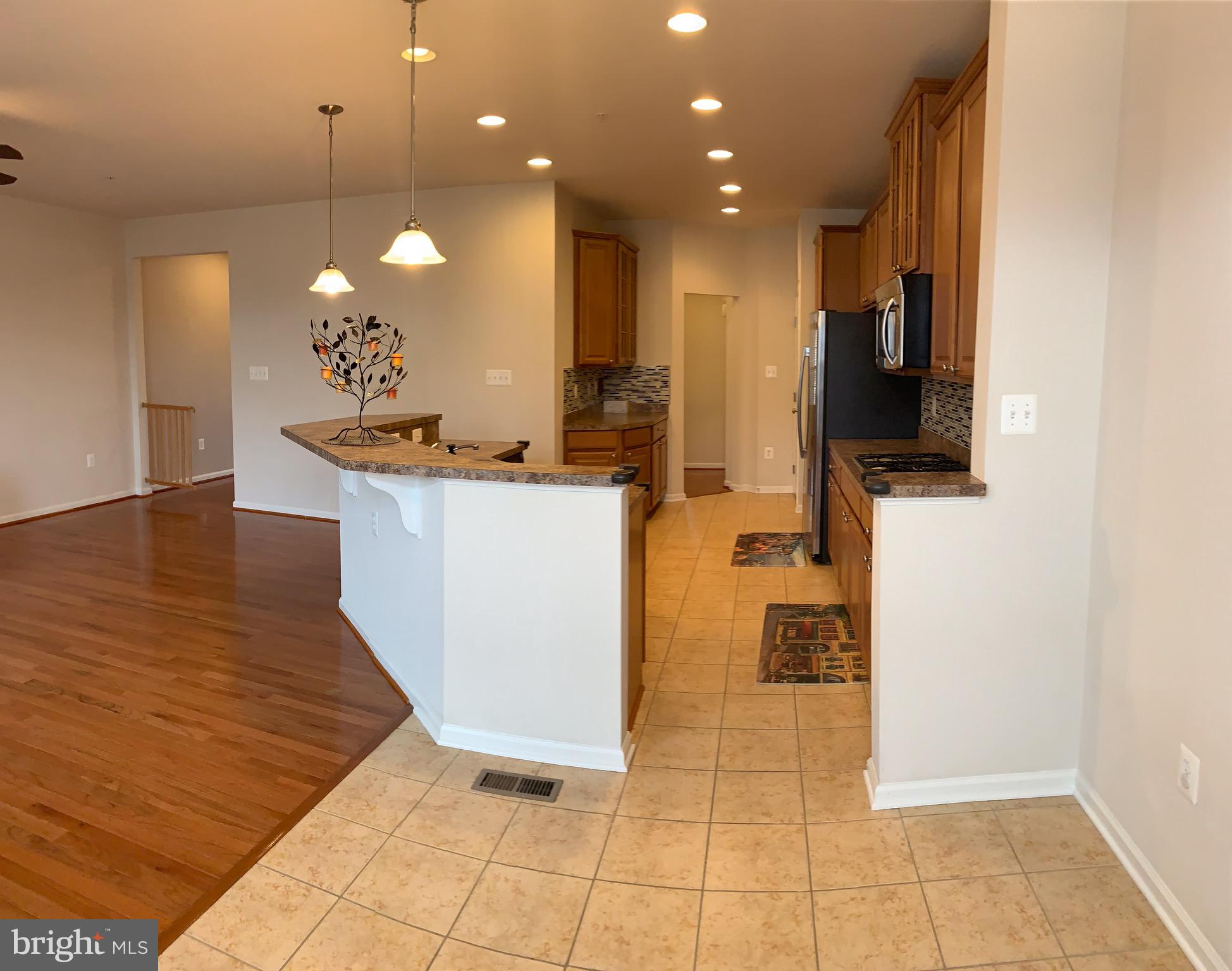 2816 Admiral Ridge Road Accokeek, MD 20607 - Photo 17 of 38 a view of a living room with kitchen island furniture and a flat screen tv