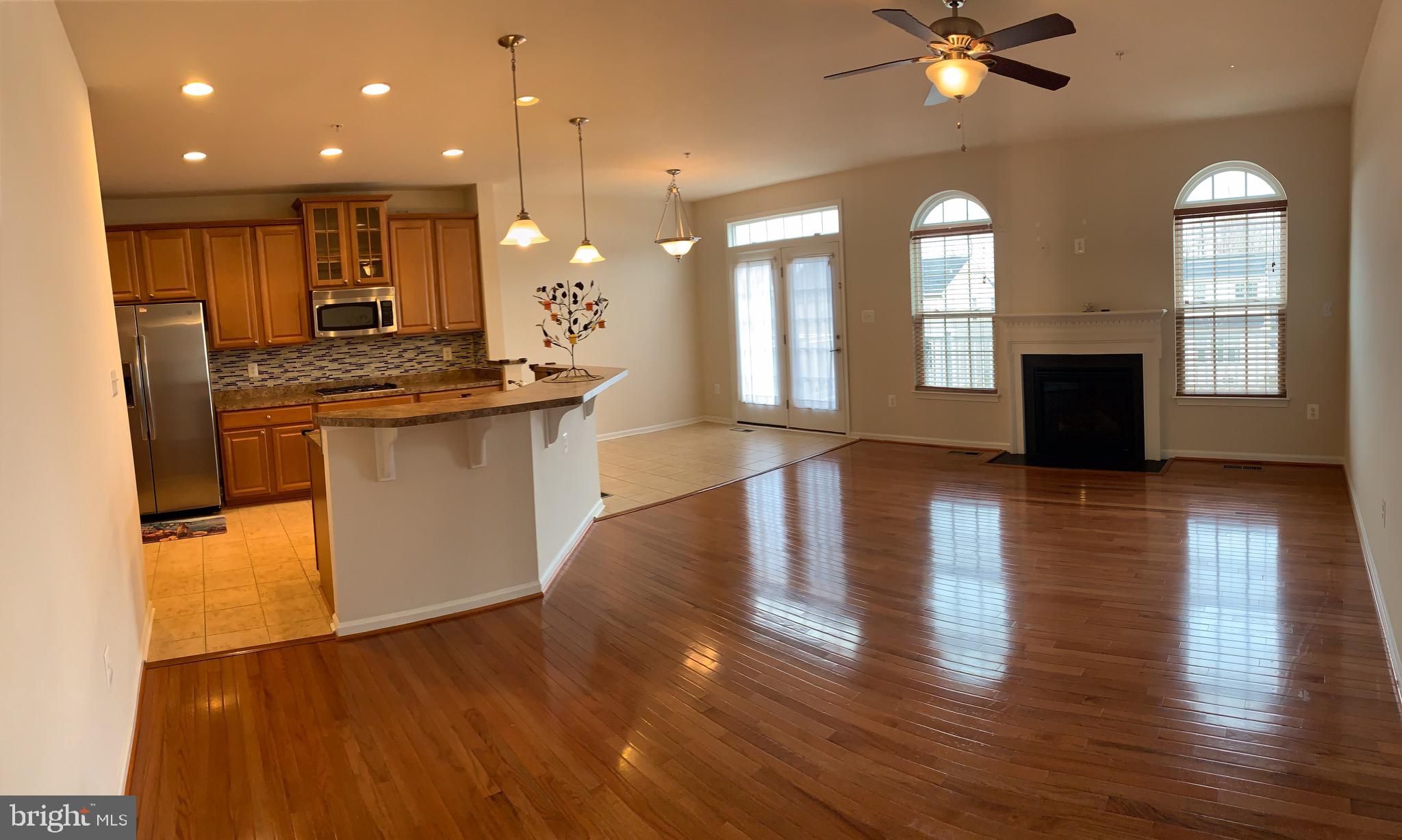 2816 Admiral Ridge Road Accokeek, MD 20607 - Photo 20 of 38 a open kitchen with white cabinets and wooden floor