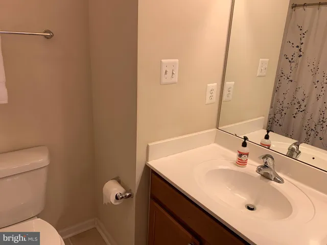 a bathroom with a sink toilet and mirror