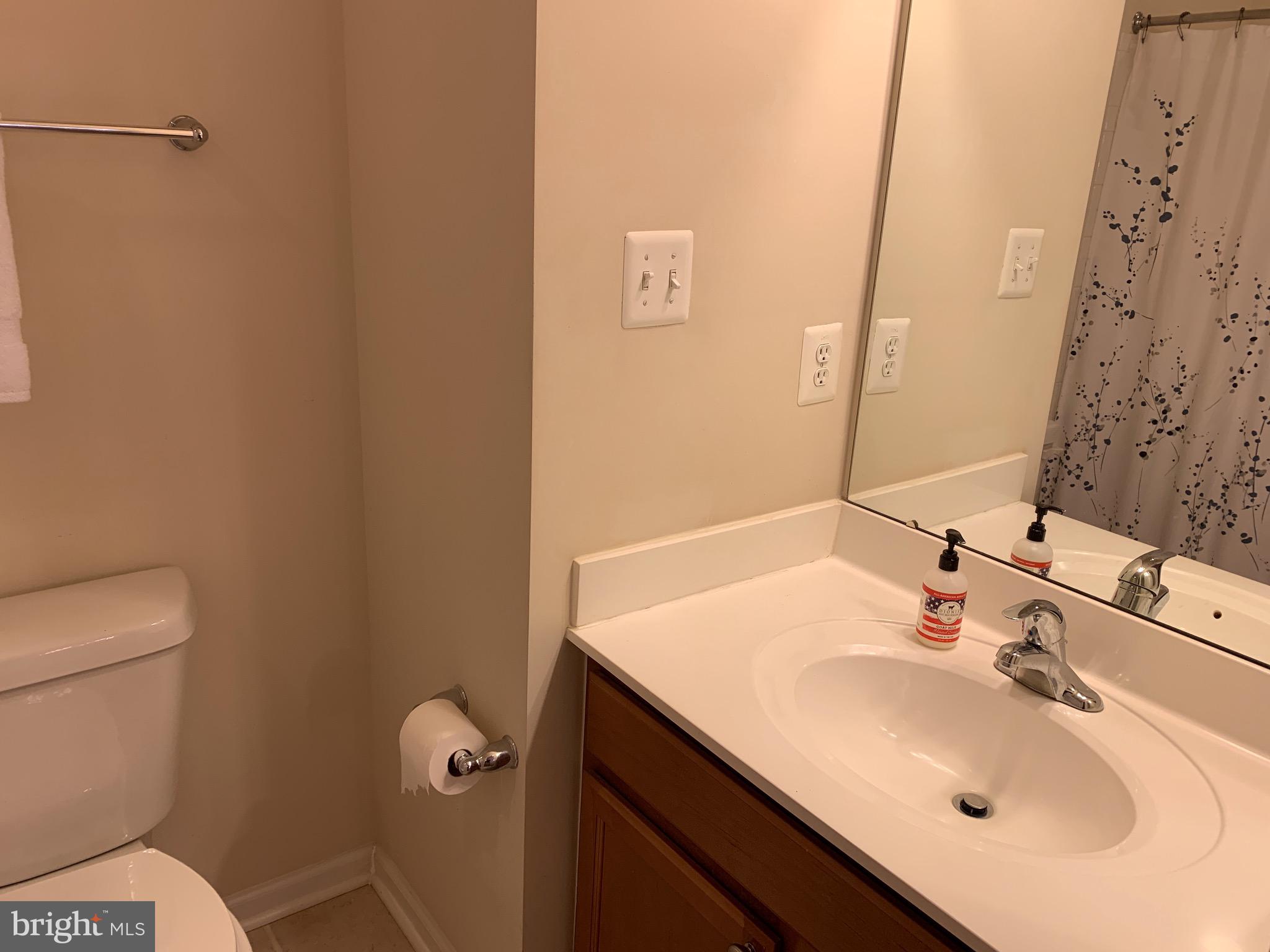 2816 Admiral Ridge Road Accokeek, MD 20607 - Photo 27 of 38 a bathroom with a sink toilet and mirror