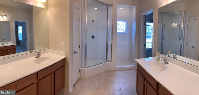 a bathroom with a sink double vanity and a mirror