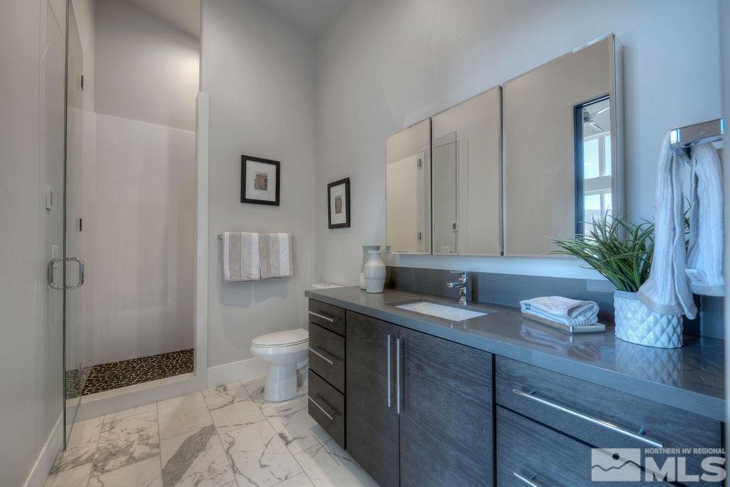 2372 Diamond J Place Reno, NV 89511 - Photo 19 of 25 a bathroom with a granite countertop sink a toilet and with mirror