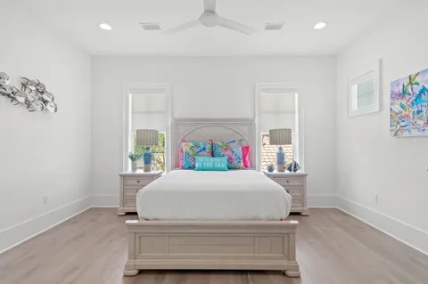 an aerial view of residential houses with outdoor space and trees