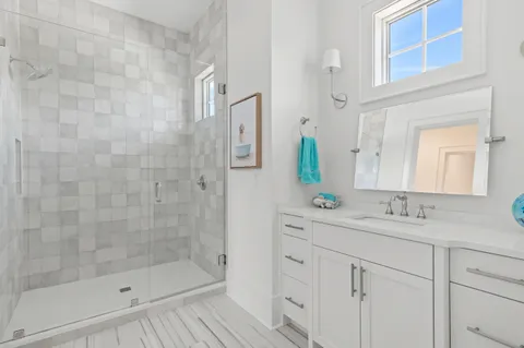 a view of a kids park in front of a house with a garage