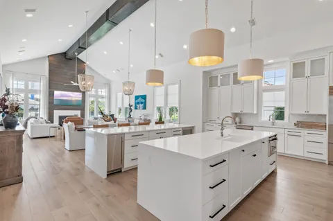 a living room with furniture a large window and a fireplace