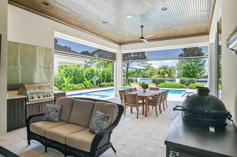 a large white kitchen with a large counter top appliances and cabinets