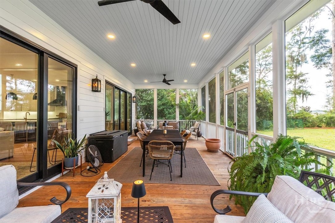 822 Dancy Avenue Savannah, GA 31419 - Photo 23 of 74 Table seating for 10-12, plus cozy couch space on either side of massive screened in porch!