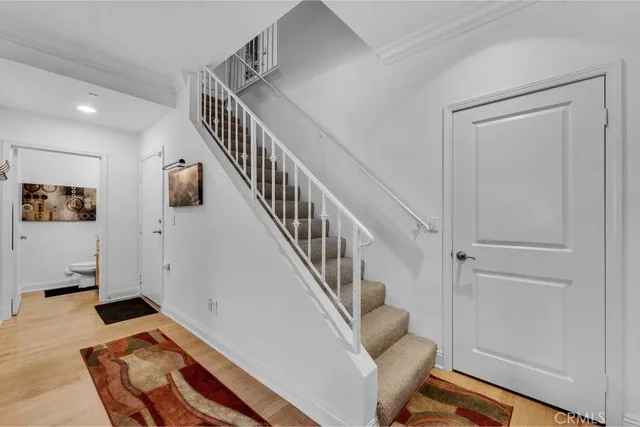 a view of entryway and hall with wooden floor