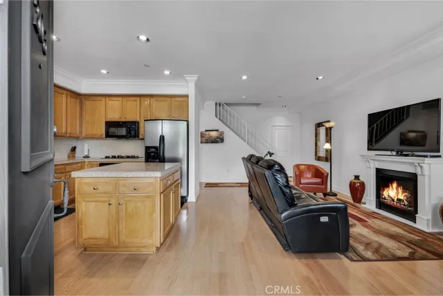 a kitchen with furniture a flat screen tv and a fireplace