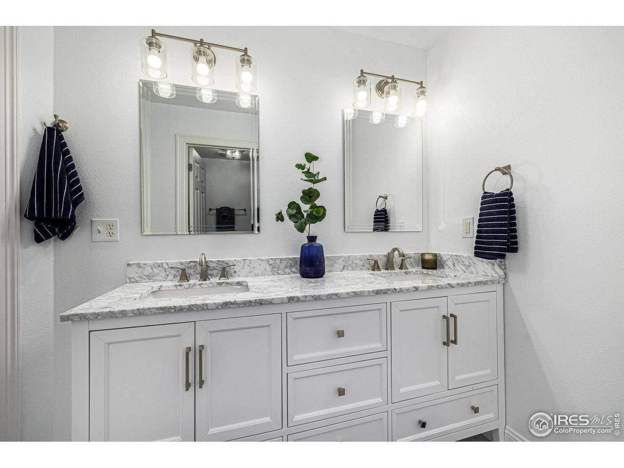 6588 Aberdour Circle Windsor, CO 80550 - Photo 23 of 40 a bathroom with a sink and a mirror
