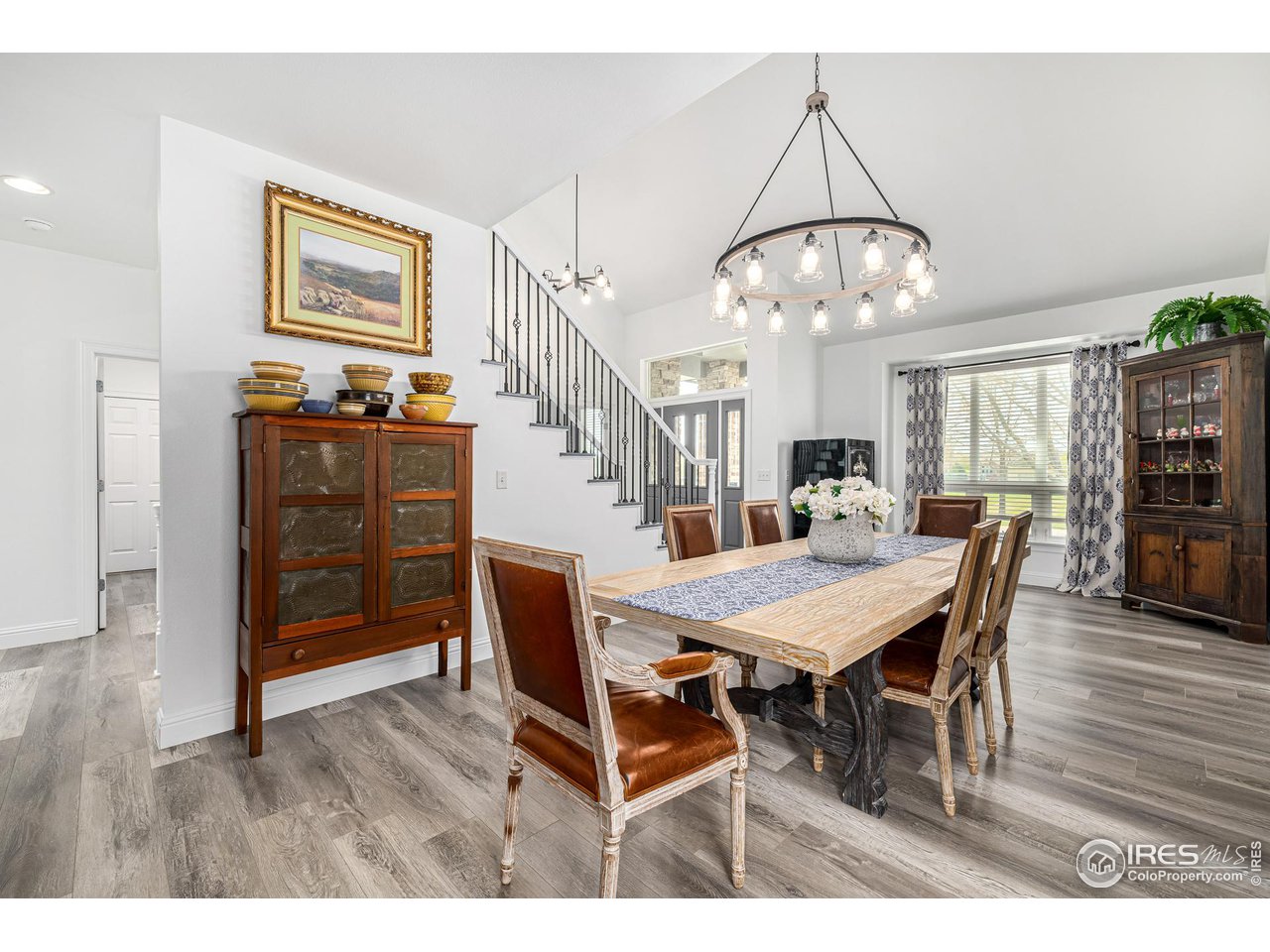 6588 Aberdour Circle Windsor, CO 80550 - Photo 6 of 40 a view of a dining room with furniture and wooden floor