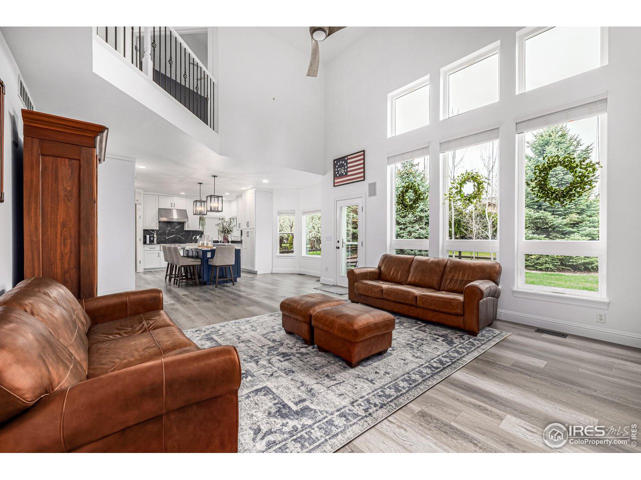 6588 Aberdour Circle Windsor, CO 80550 - Photo 8 of 40 a living room with furniture and a large window