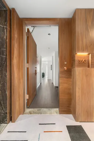 a view of a hallway with wooden floor and staircase