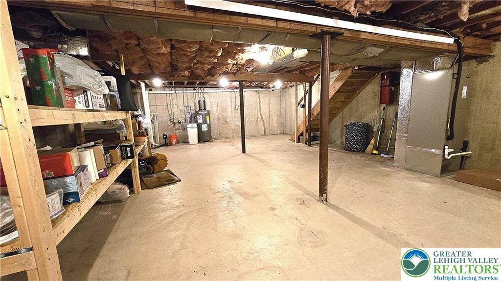 194 Springhouse Road Allentown, PA 18104 - Photo 31 of 34 This spacious unfinished basement offers ample potential for customization and additional living space.