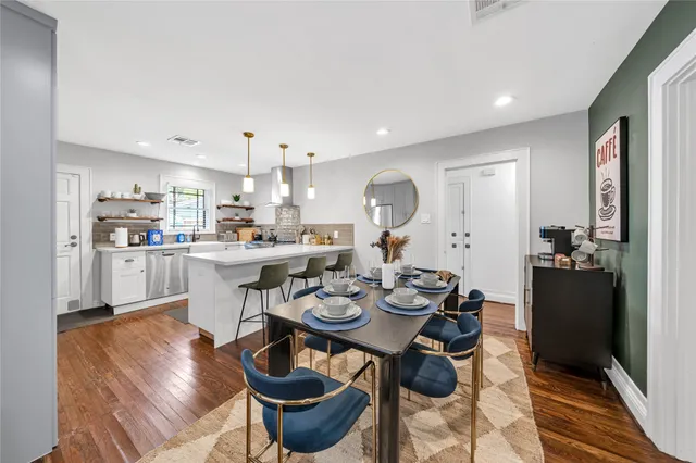 a open dining room with kitchen island furniture a chandelier and kitchen view