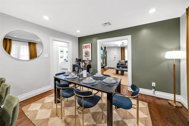 a view of a dining room with furniture and wooden floor