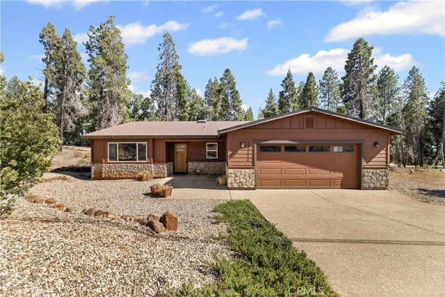 a front view of a house with a yard covered with snow in front of house