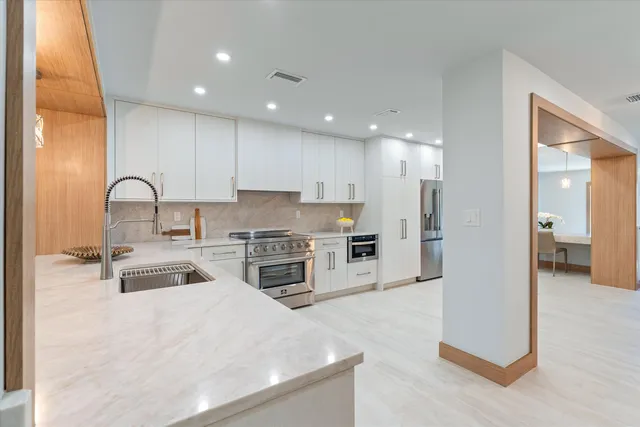 a kitchen with stainless steel appliances refrigerator oven and microwave