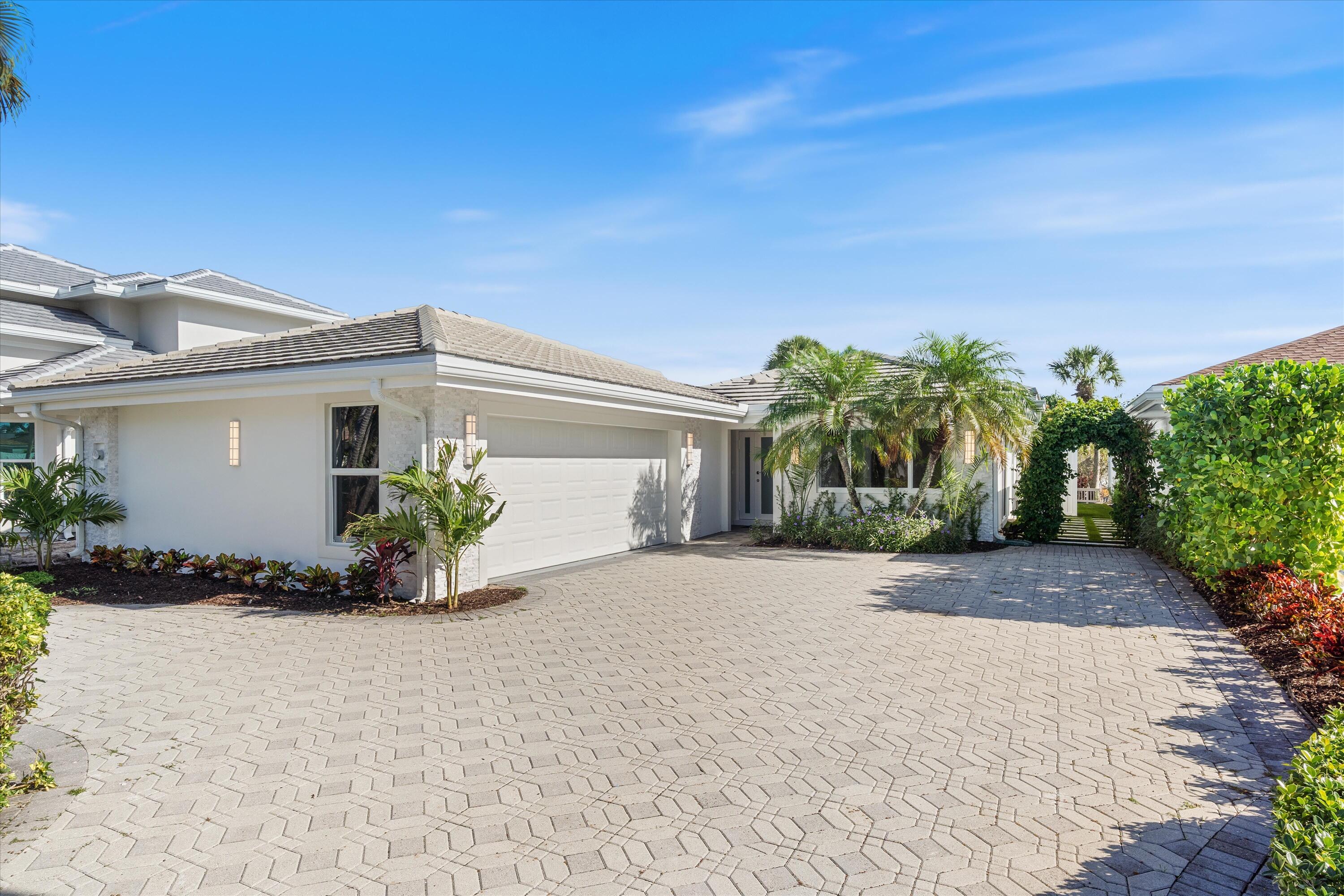 17036 Bay Street Jupiter, FL 33477 - Photo 2 of 68 a front view of a house with a yard