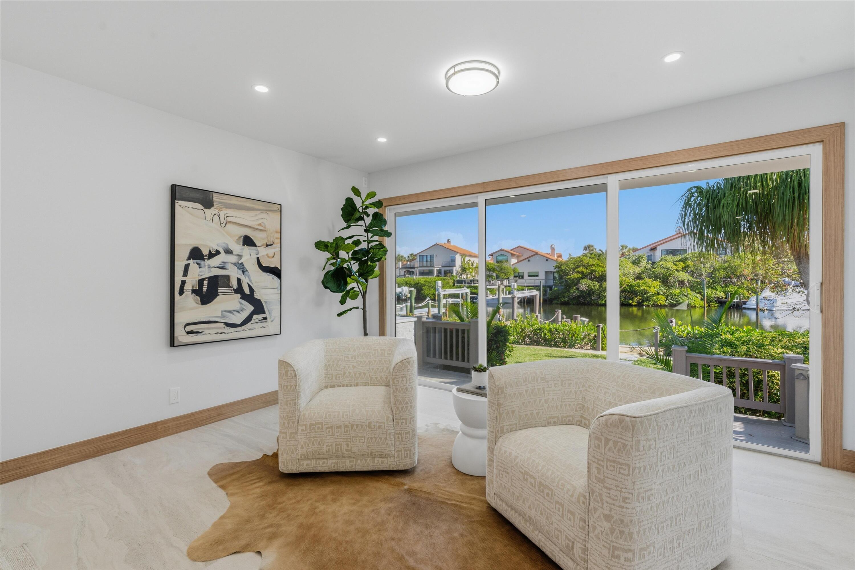 17036 Bay Street Jupiter, FL 33477 - Photo 31 of 68 a living room with furniture and a large window