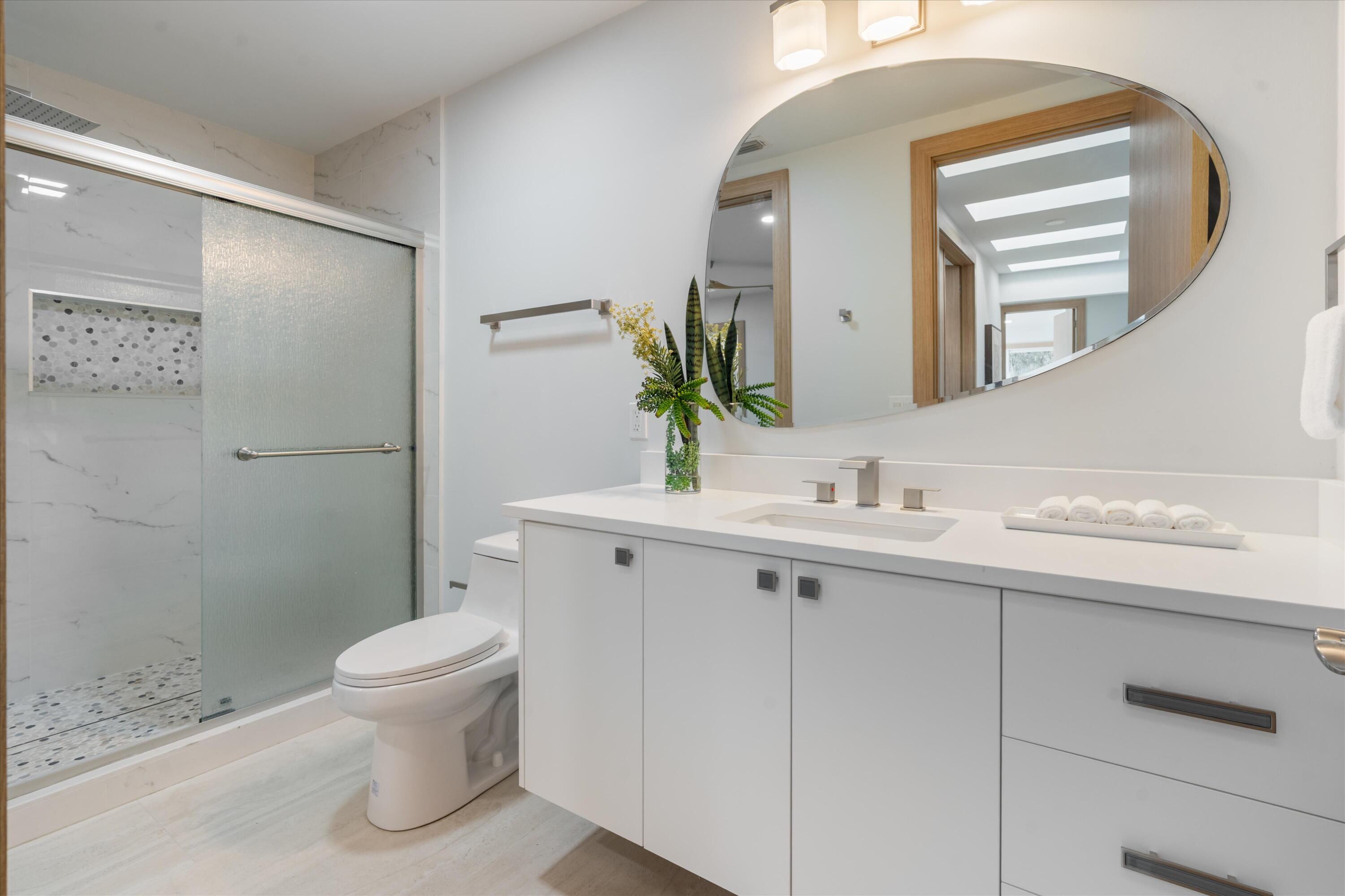 17036 Bay Street Jupiter, FL 33477 - Photo 38 of 68 a bathroom with a sink a toilet and shower