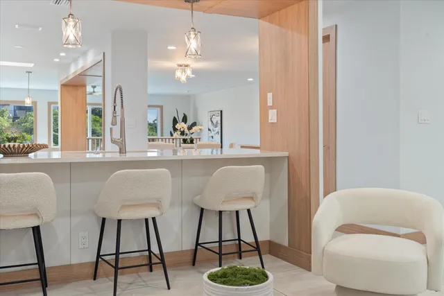 a kitchen with granite countertop a stove a sink and a refrigerator