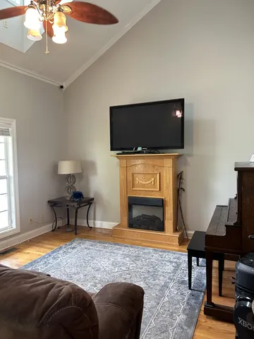 a living room with a flat screen tv and a fireplace