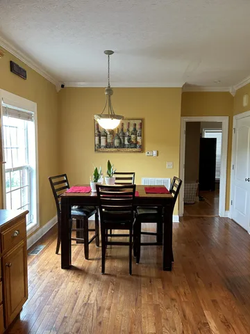 a view of a dining room with furniture and wooden floor