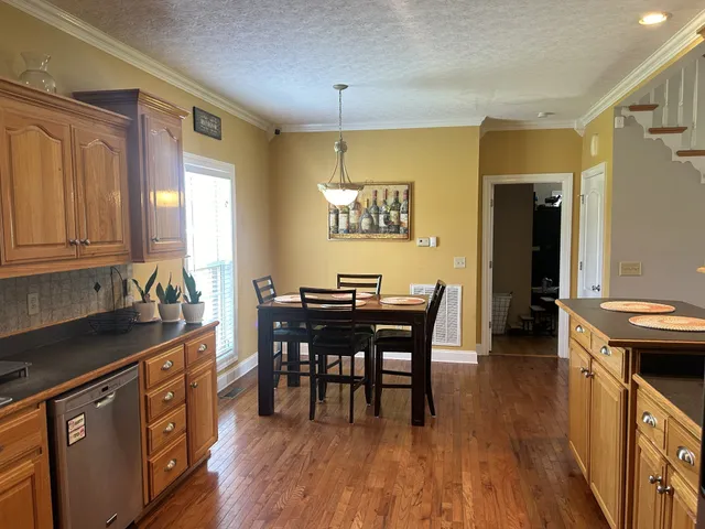 a kitchen with stainless steel appliances granite countertop a sink and cabinets