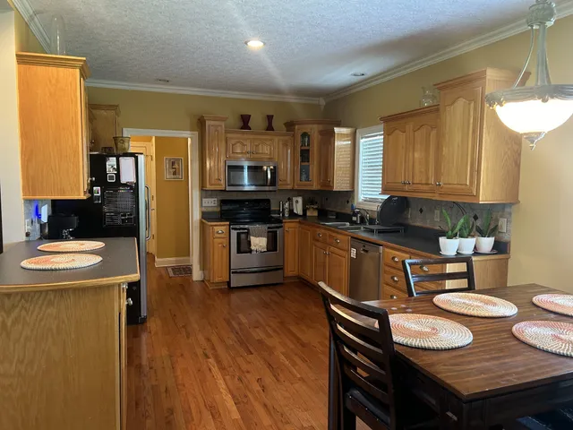 a kitchen with stainless steel appliances a refrigerator and a stove top oven