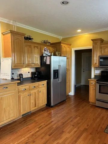 a kitchen with stainless steel appliances a refrigerator sink and microwave
