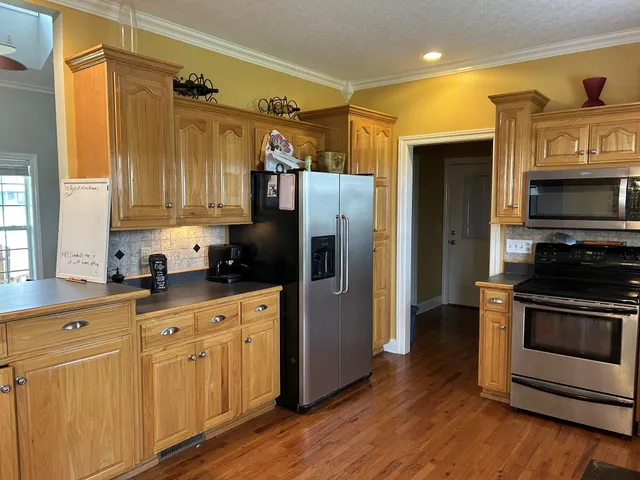 a kitchen with white cabinets and stainless steel appliances