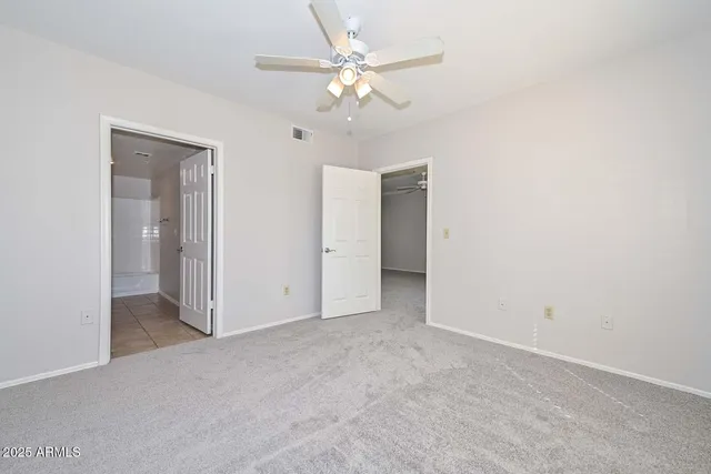 an empty room with fan and a ceiling fan